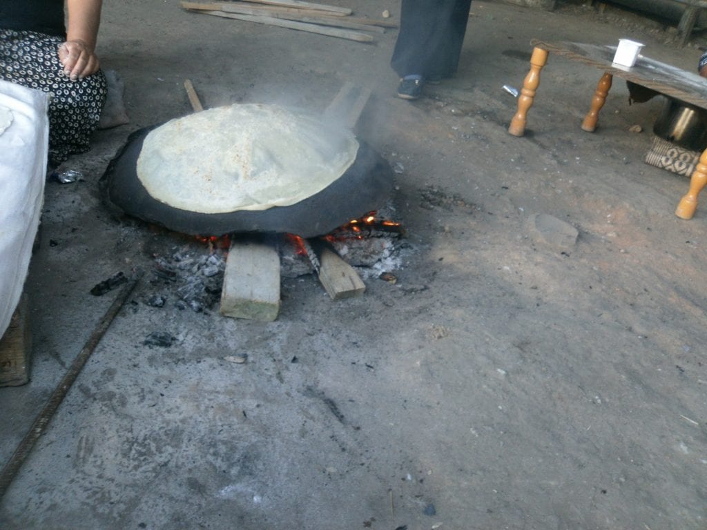 Saja, Khasham Zanneh Using the Tabun (Arabic), a traditional open