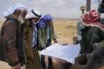 Men from the area of al-Baggār look at a map of their lands that are not recognized by the state, 04.03.2015 (Michal Rotem / NCF)